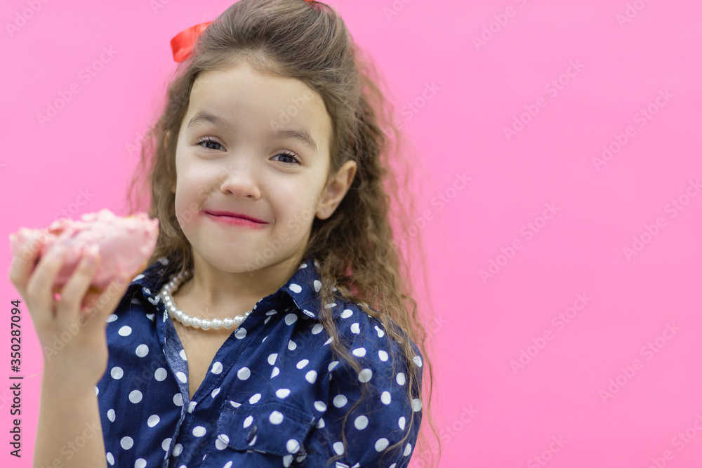 Funny smiling little girl with colorful donut on empty background. Funny smiling little girl with colorful donut on empty background.