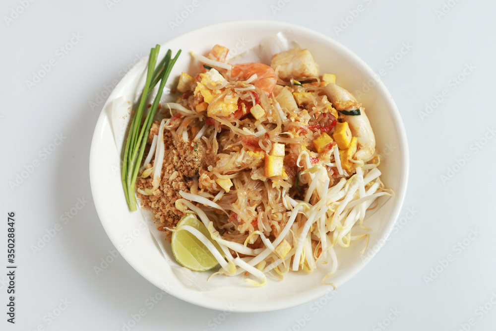 Fried noodle Thai style with prawns Thailand call Pad Thai, Stir-fried noodle Thai style on the wood table.