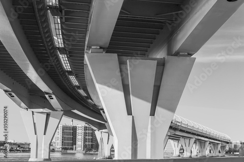 bottom view of a high-speed bridge over the Gulf of Finland against the sky. Black and white photography