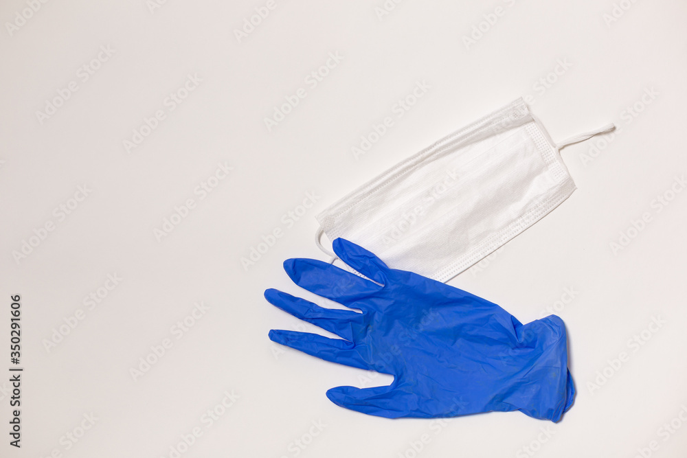 latex gloves and medical mask on white background
