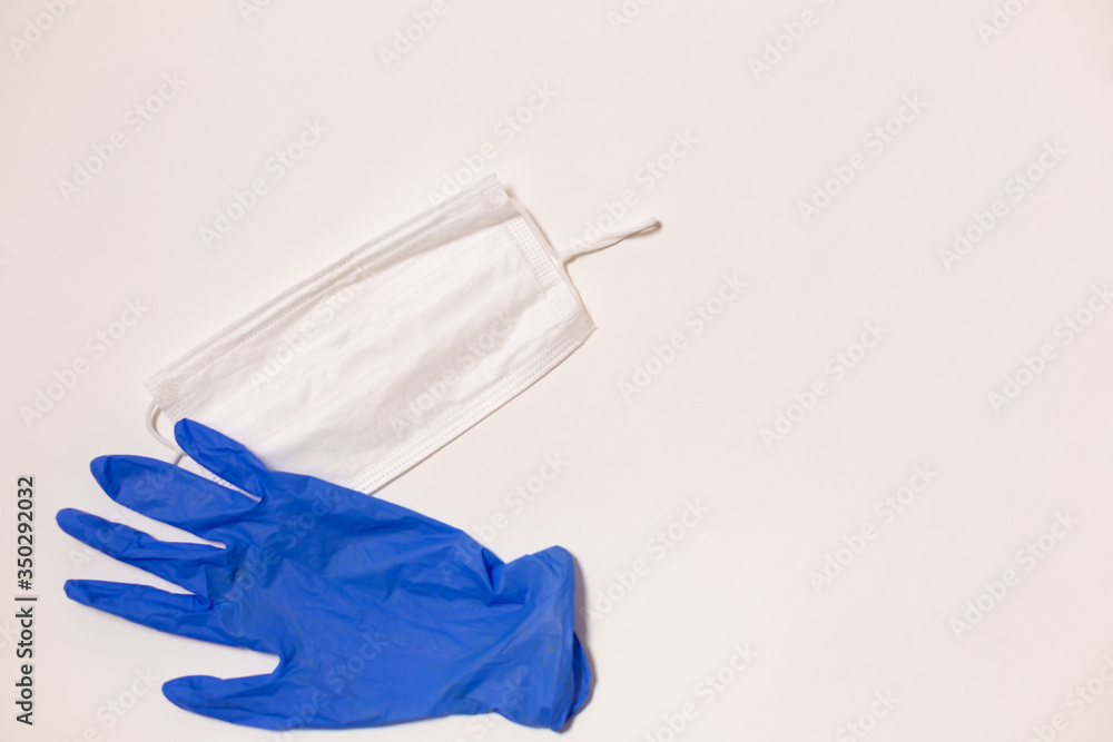 latex gloves and medical mask on white background