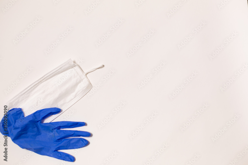 latex gloves and medical mask on white background