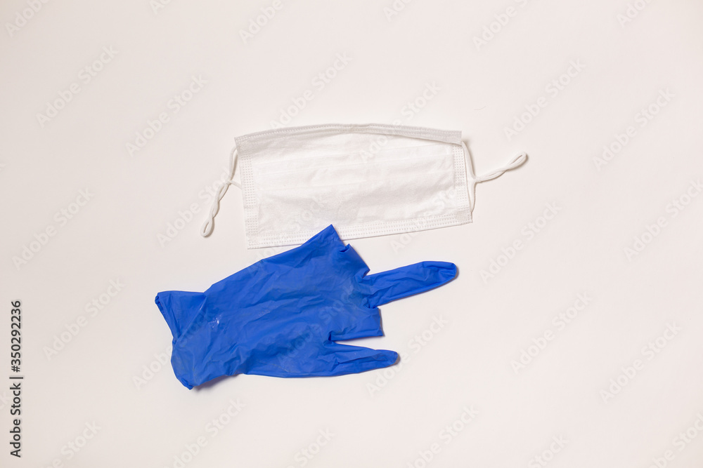latex gloves and medical mask on white background