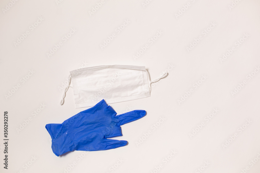 latex gloves and medical mask on white background