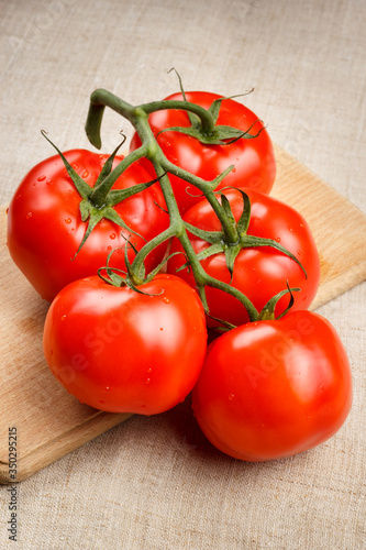 Juicy red tomatoes on a cutting board