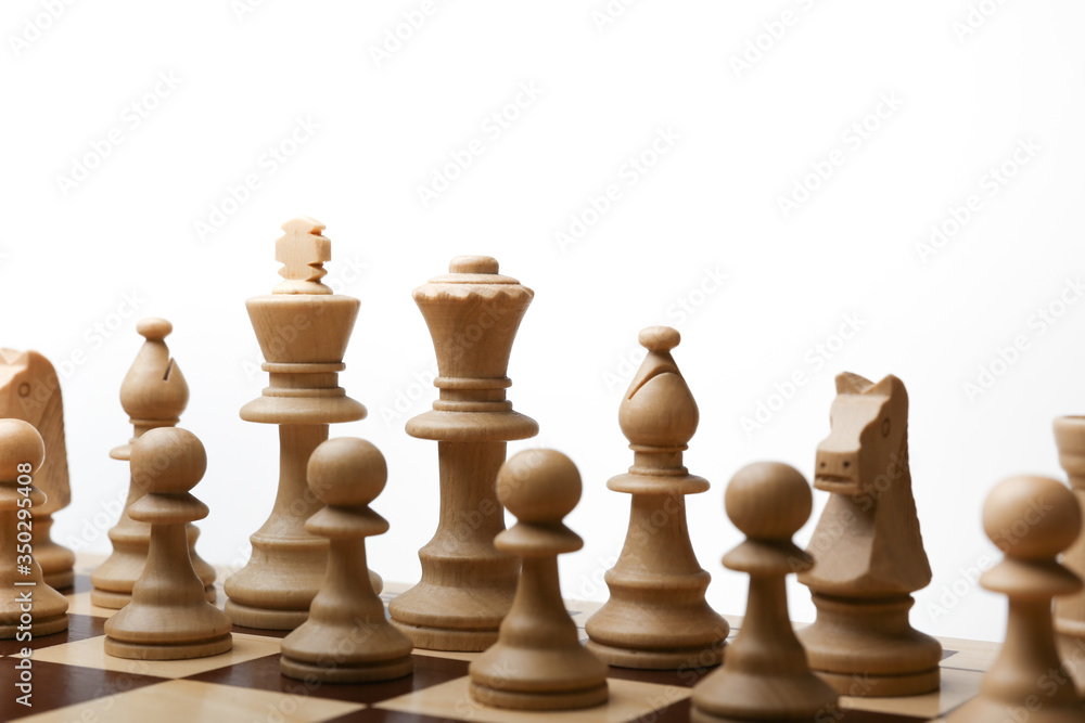 army of white chess pieces on the board at the beginning of the game on white background. army of white chess pieces on the board at the beginning of the game on white background.