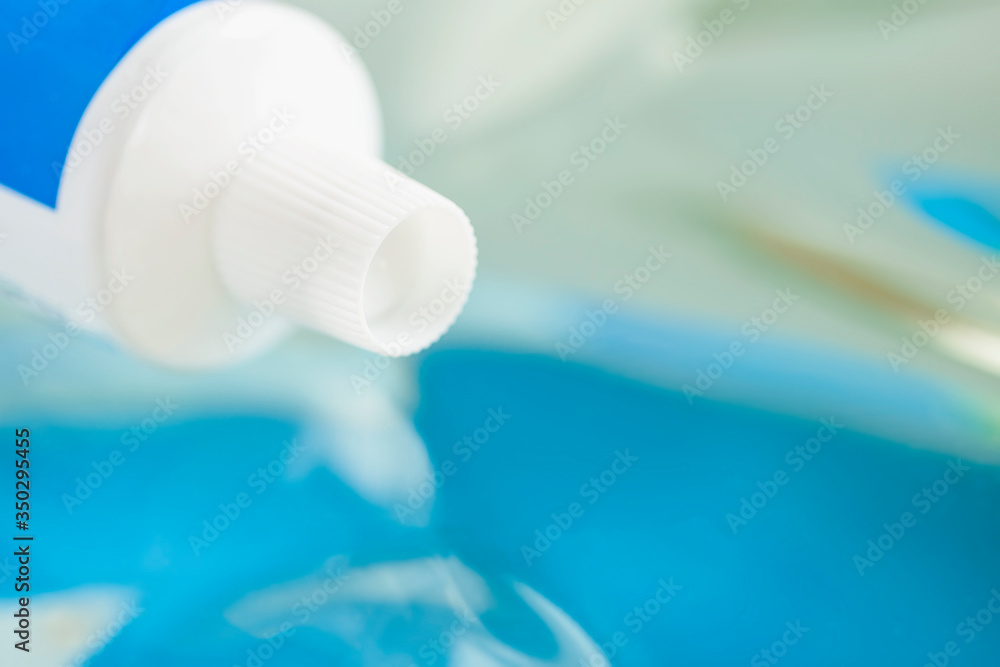 Closeup of tube toothpaste on light background, selective focus Closeup of tube toothpaste on light background, selective focus
