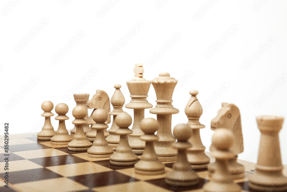 army of white chess pieces on the board at the beginning of the game on white background. army of white chess pieces on the board at the beginning of the game on white background.