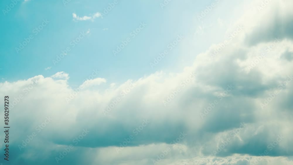 Sun Rays Shining Through Cloudy Sky With Fluffy Clouds. Natural Background Sun Rays Shining Through Cloudy Sky With Fluffy Clouds. Natural Background