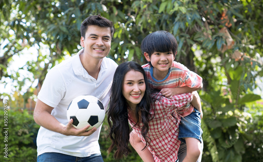 Happy family, All three are playing on the lawn in front of the house, The concept of happy family relationships and free time together. Happy family, All three are playing on the lawn in front of the house, The concept of happy family relationships and free time together.