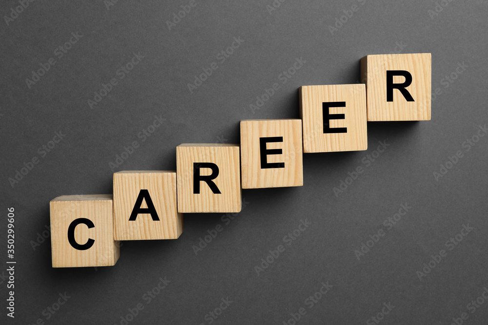 Wooden cubes with word CAREER on dark background, flat lay Wooden cubes with word CAREER on dark background, flat lay