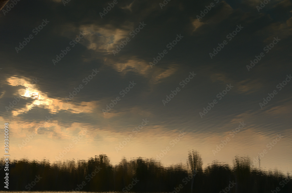 Landscape by the river. Mirror on the water. Water reflection. Boat near the water. The boatman in the fog. The rays of the sun on the water. Ukraine Landscape by the river. Mirror on the water. Water reflection. Boat near the water. The boatman in the fog. The rays of the sun on the water. Ukraine