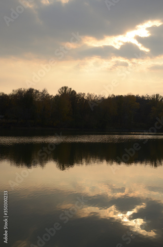 Landscape by the river. Mirror on the water. Water reflection. Boat near the water. The boatman in the fog. The rays of the sun on the water. Ukraine © александр Гуменюк