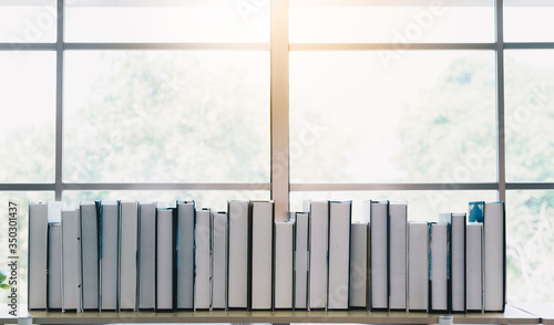 stack of book on book shelf in house photo