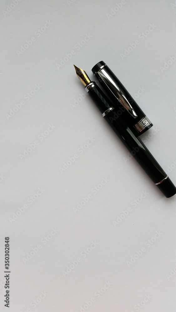 fountain pen on a white paper. Isolated on white background. fountain pen on a white paper. Isolated on white background.