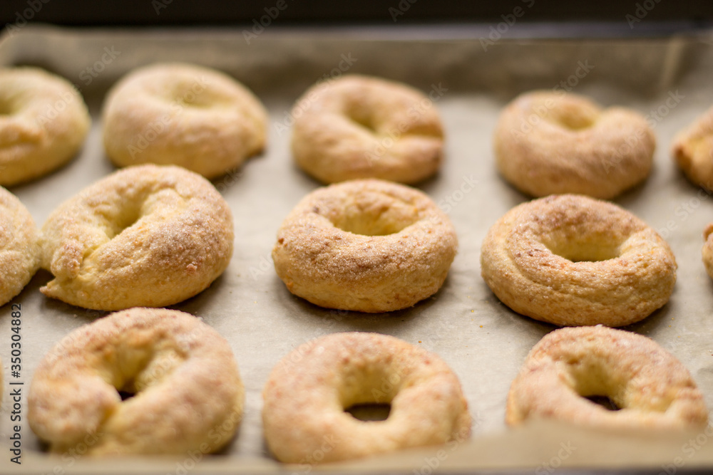 Homemade cookies. Cottage cheese rings on a baking sheet, healthy sweets. Bake at home. Family traditions. Selective focus