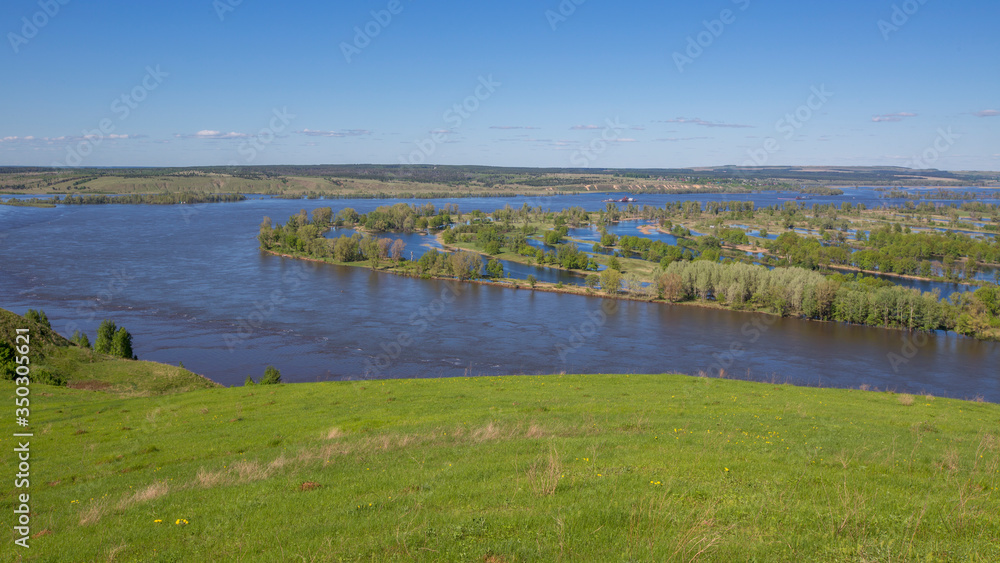 beautiful view of the Kama River and water meadows from a high bank on a sunny summer day beautiful view of the Kama River and water meadows from a high bank on a sunny summer day