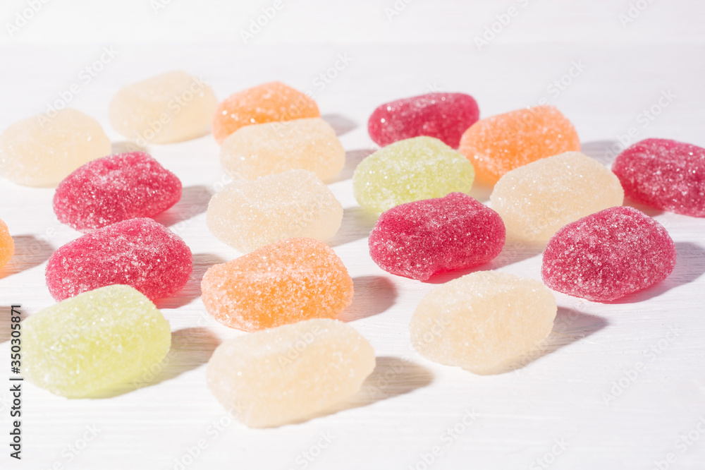 Fruit colorful marmalade sweets, jelly candies on white wooden background Fruit colorful marmalade sweets, jelly candies on white wooden background