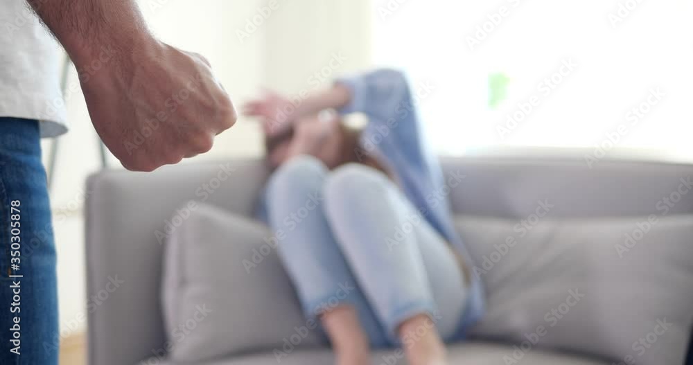 Man threatening his girlfriend in room. Domestic violence