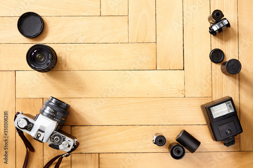 Old camera and photographic equipment on wooden floor