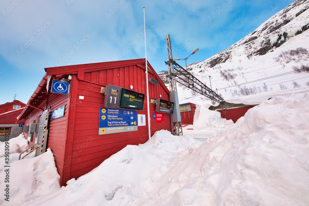 Naklejka premium FLAM, NORWAY - 20th Feb, 2018: The train stops at the flam station. The Flam Line is between Myrdal and Flam in Aurland, Norway, the mainline of the Bergen Line.