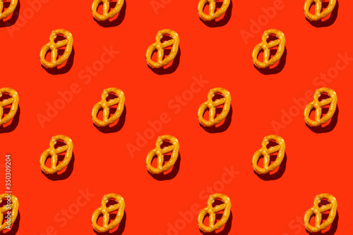 isometric flat lay with salty bagels on red background, summer minimal pattern