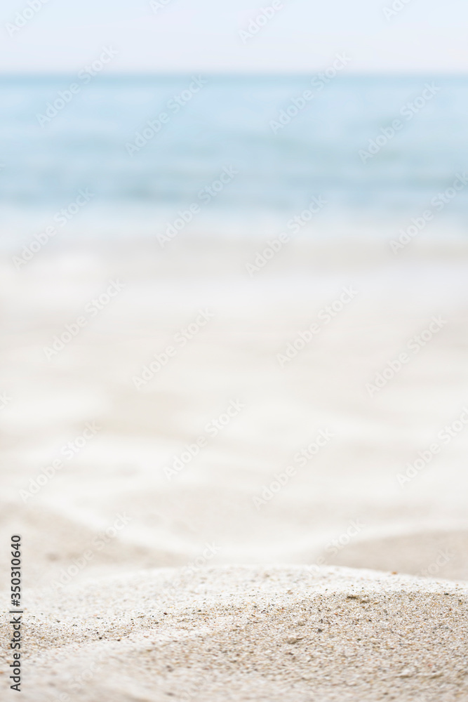 blurred of the sea and sand in the summer for abstract background