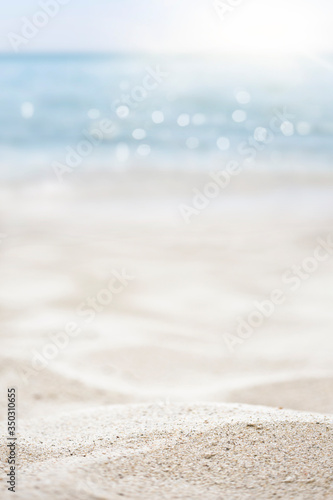 blurred of the sea and sand in the summer for abstract background © Alina G