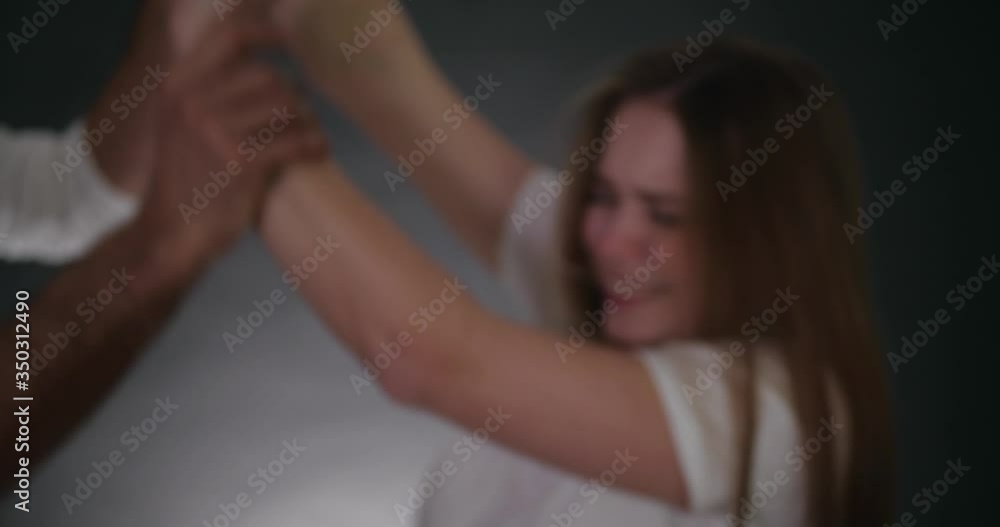 Blurred view of man shaking his girlfriend on grey background. Domestic violence Blurred view of man shaking his girlfriend on grey background. Domestic violence