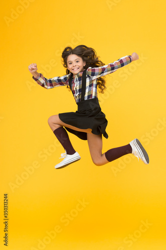 Be happy everyday. Happy child in midair yellow background. Having fun. Happy childhood. Raising happy kid. School holidays. International childrens day © be free