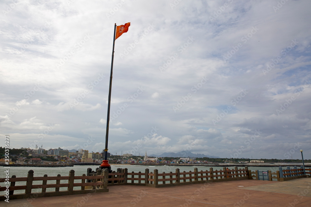 A saffron flag with Om inscribed on it waving in The Swami Vivekananda Rock Memorial, Kanyakumari