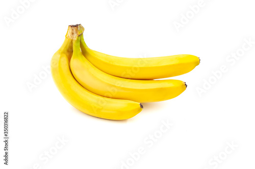 Three bananas isolated on white background. Banana bunch. Creative healthy food concept. Flat lay.