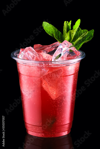 Cold fizz cocktail with strawberry in take away cup isolated on black background