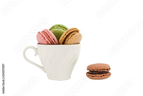 Macaroons in a cup and a dark brown macaroon