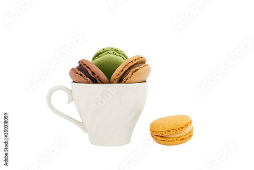 Macaroons in a cup and a yellow macaroon
