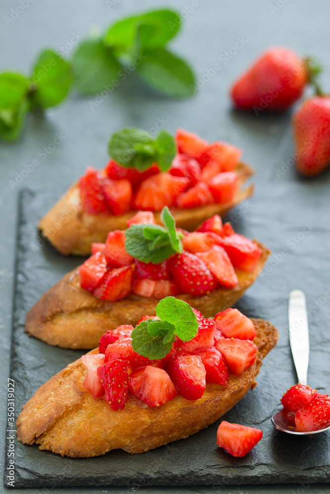 Bruschetta with strawberries and basil. Selective focus Bruschetta with strawberries and basil. Selective focus