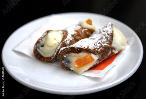 Fresh italian cannoli on the table in sicilian cafe. Delicious desert. Sweet lifestyle.