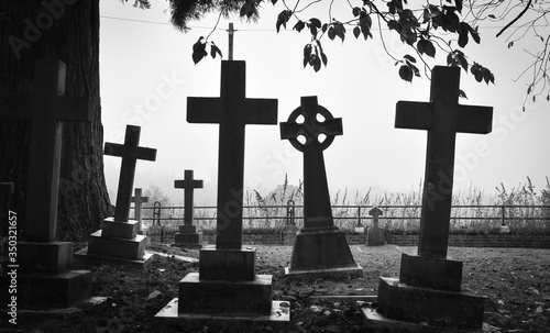 Fotografie, Tablou Cross On Cemetery Against Sky