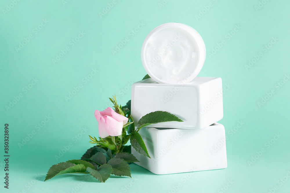 Unbranded white container with moisturizing cream for dry and damaged skin on turquoise pastel background. Skin care concept. Unbranded white container with moisturizing cream for dry and damaged skin on turquoise pastel background. Skin care concept.