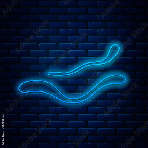 Glowing neon line Ebola virus disease icon isolated on brick wall background. Vector Illustration