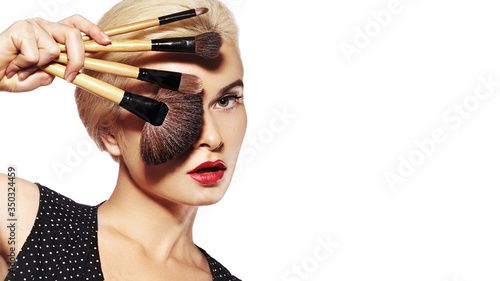 Girl with Makeup Beauty Brushes. Fashion Make-up for Sexy Woman. Make-up Artist Applying Visage on white background photo