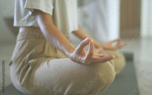 Close up woman hands with locked fingers during meditation yoga