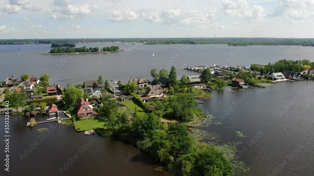 4k aerial video of cultivated dutch landscape with houses on small islands and dike because of peat excavation at the Loosdrechtse plassen 4k aerial video of cultivated dutch landscape with houses on small islands and dike because of peat excavation at the Loosdrechtse plassen