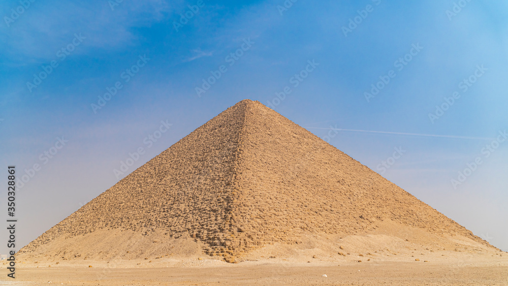 The Bent Pyramid is an ancient Egyptian pyramid located at the royal necropolis of Dahshur, approximately 40 kilometres south of Cairo, built under the Old Kingdom Pharaoh Sneferu. Egypt