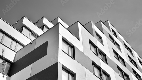 Detail of modern residential flat apartment building exterior. Fragment of new luxury house and home complex. Black and white.