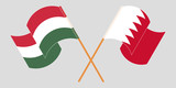 Crossed and waving flags of Hungary and Bahrain