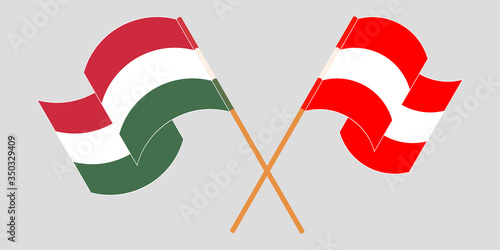 Crossed and waving flags of Hungary and Austria