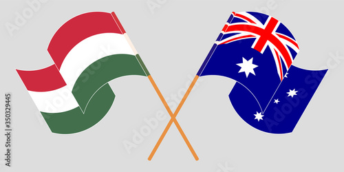 Crossed and waving flags of Hungary and Australia