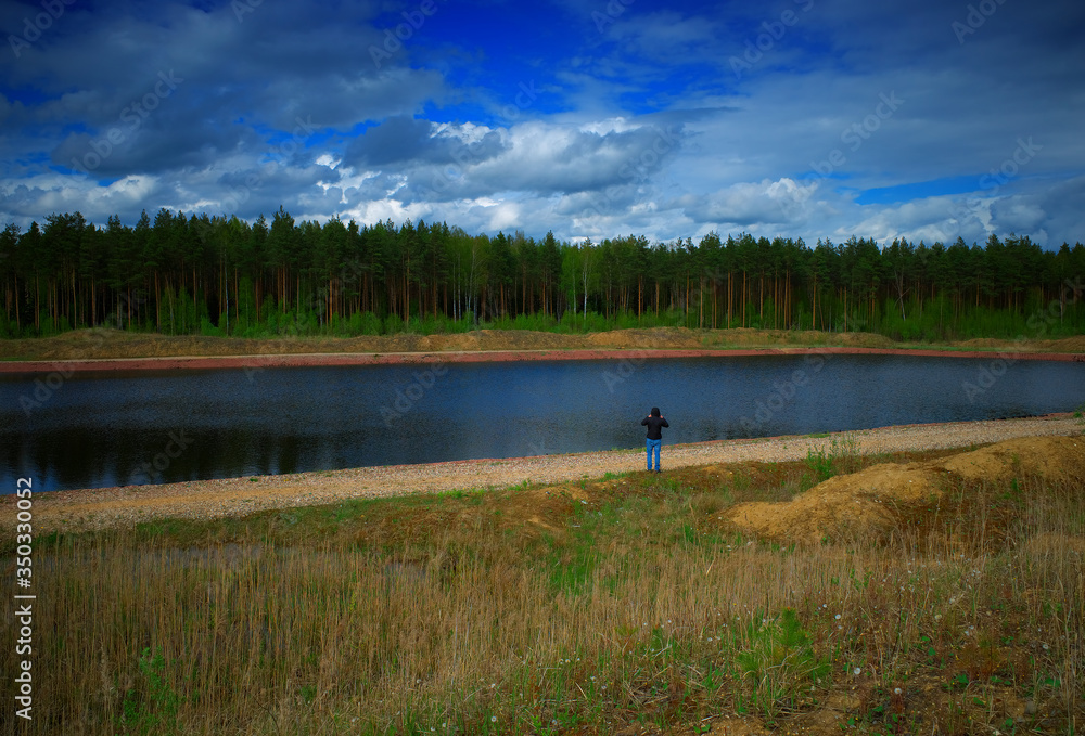 Man standing on summer river bank background