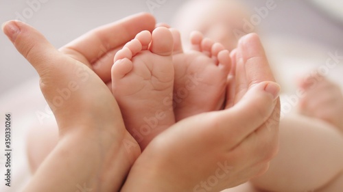 Close up, Baby feet in mothers hands. Happy Family concept.  © CameraCraft